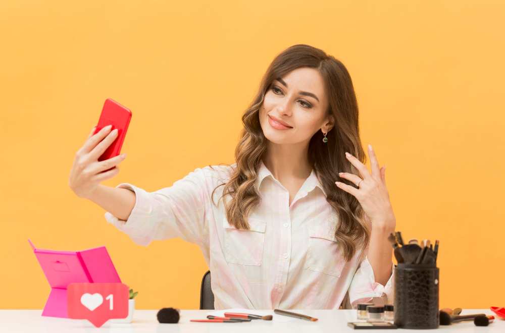 A young woman taking a photo and recording a video clip, possibly for an influencer marketing campaign, with a camera or smartphone in hand and a creative backdrop or setting.